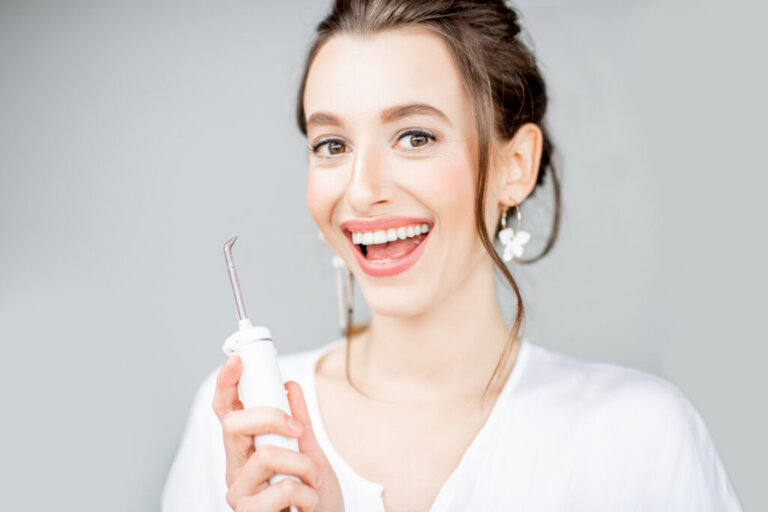Portrait,Of,A,Beautiful,Woman,With,Shiny,Smile,Holding,Irrigator